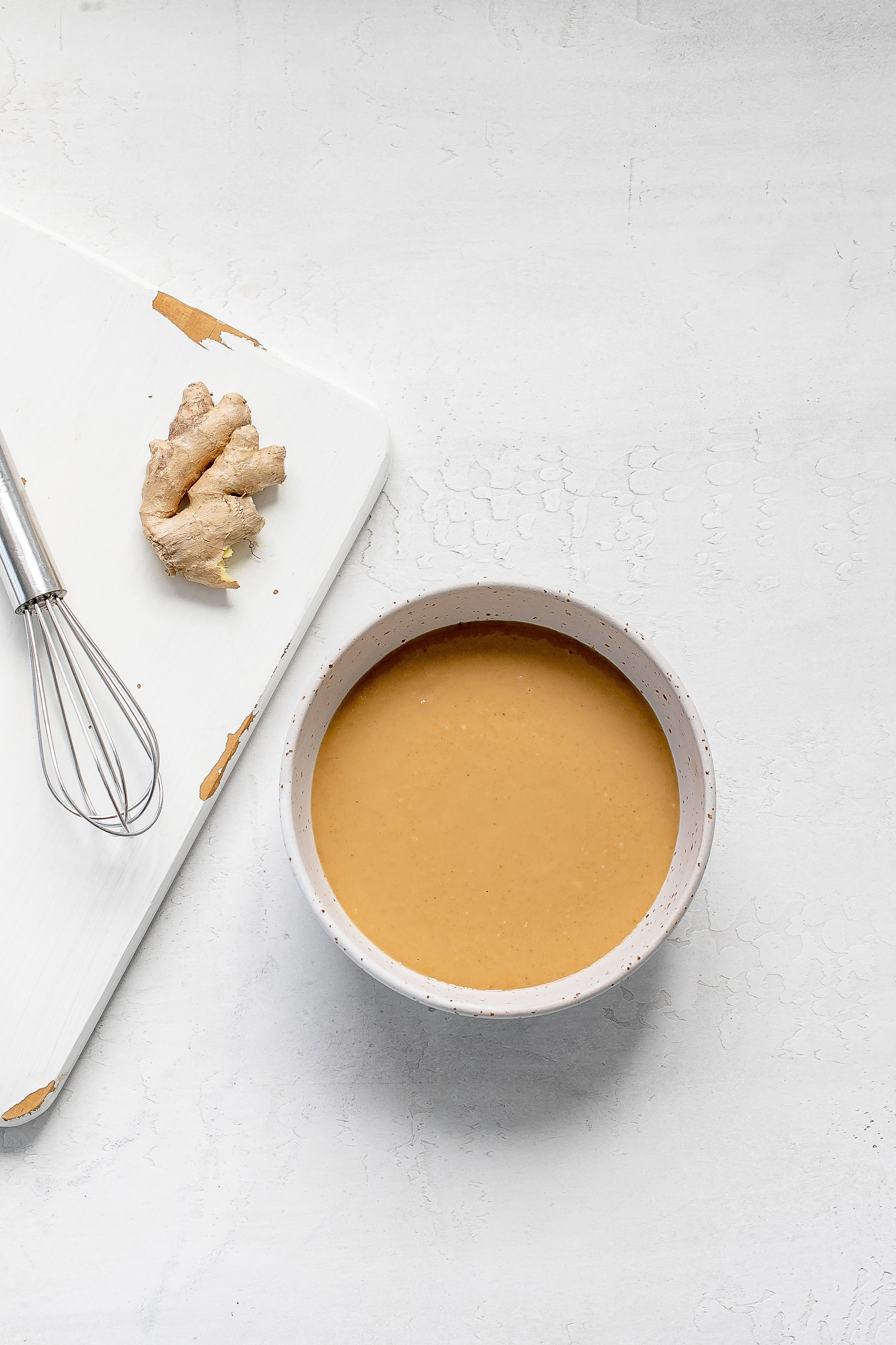 miso dressing in bowl with whisk. 