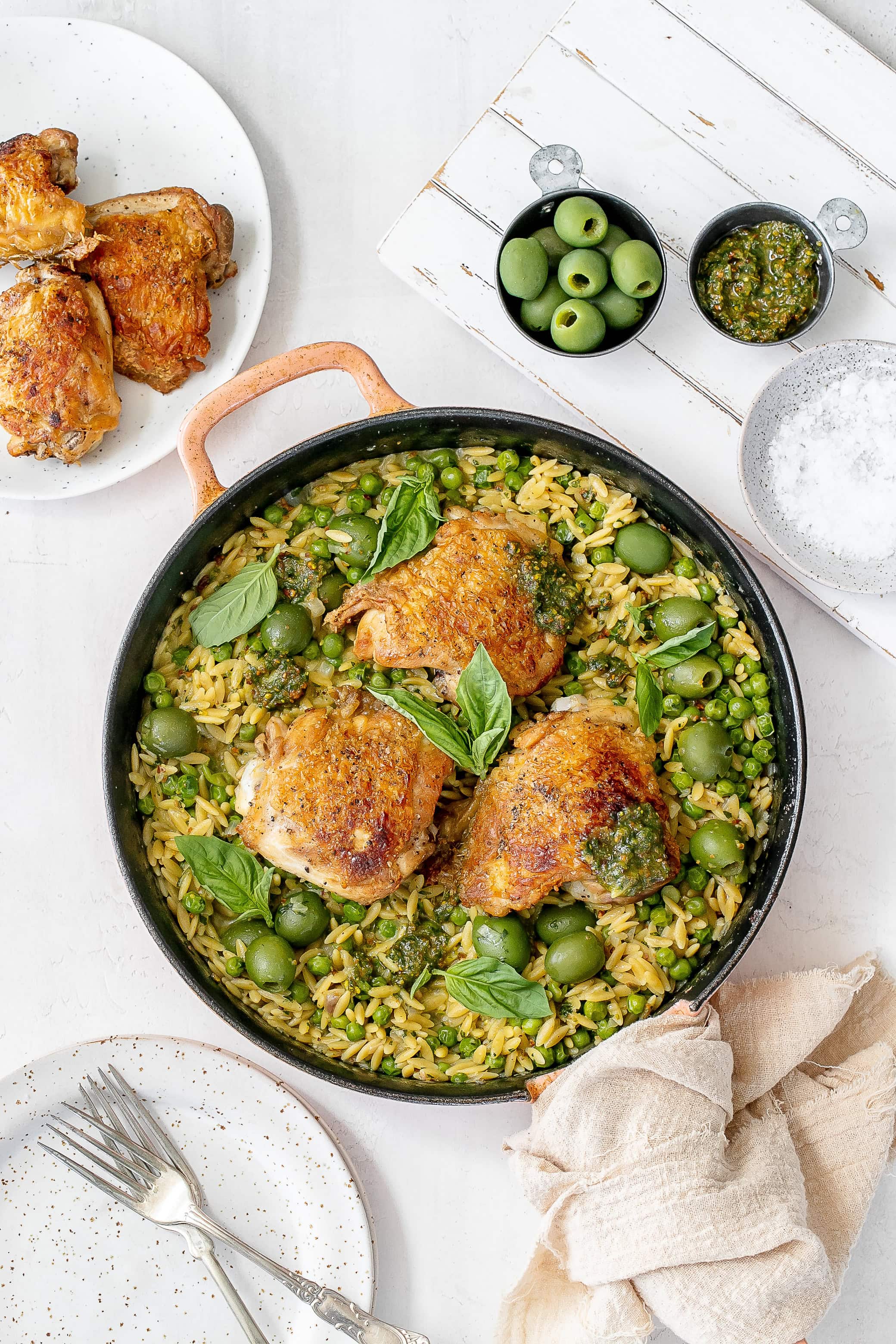 pesto chicken and orzo in cast iron skillet.
