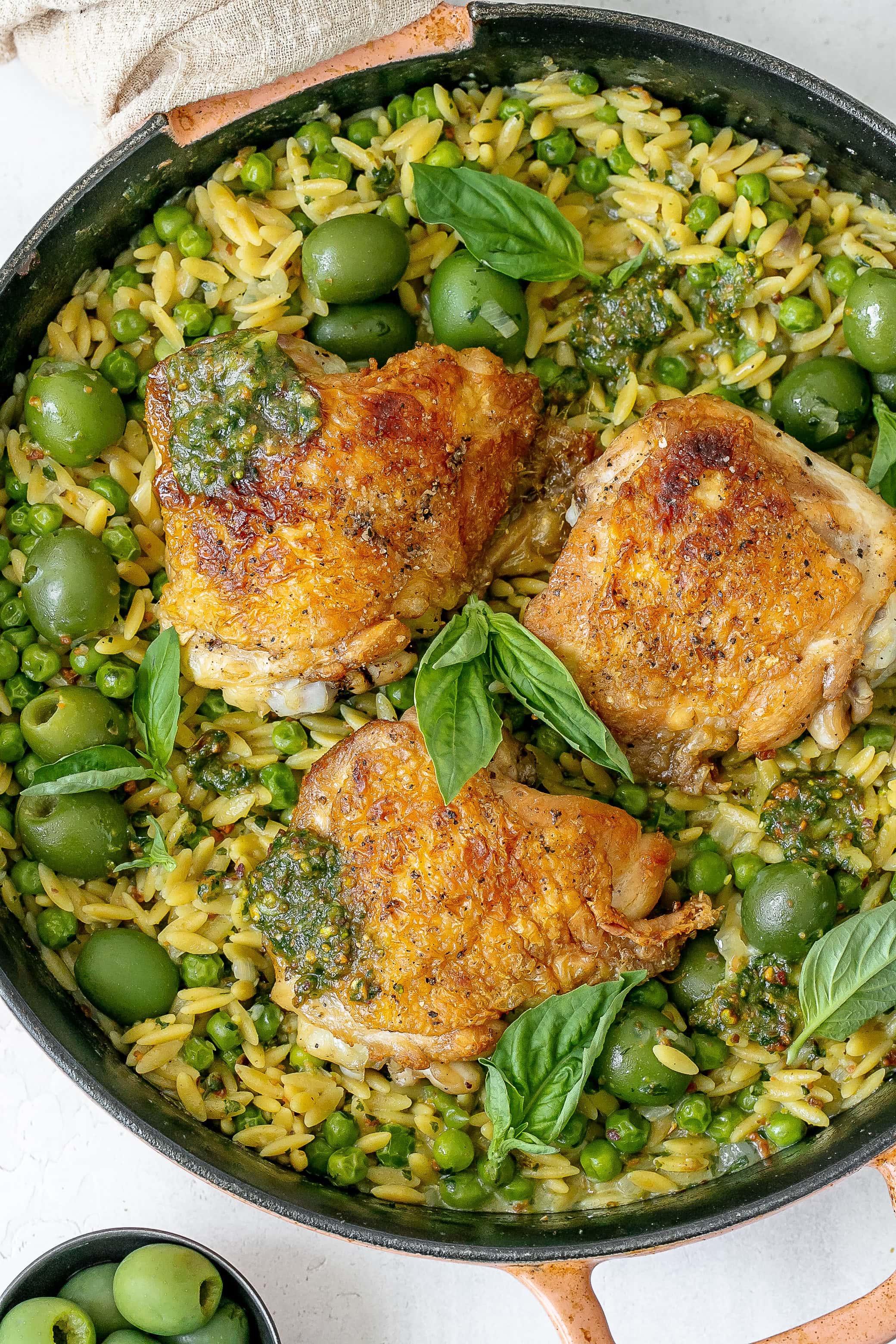 pesto chicken and orzo in cast iron skillet.