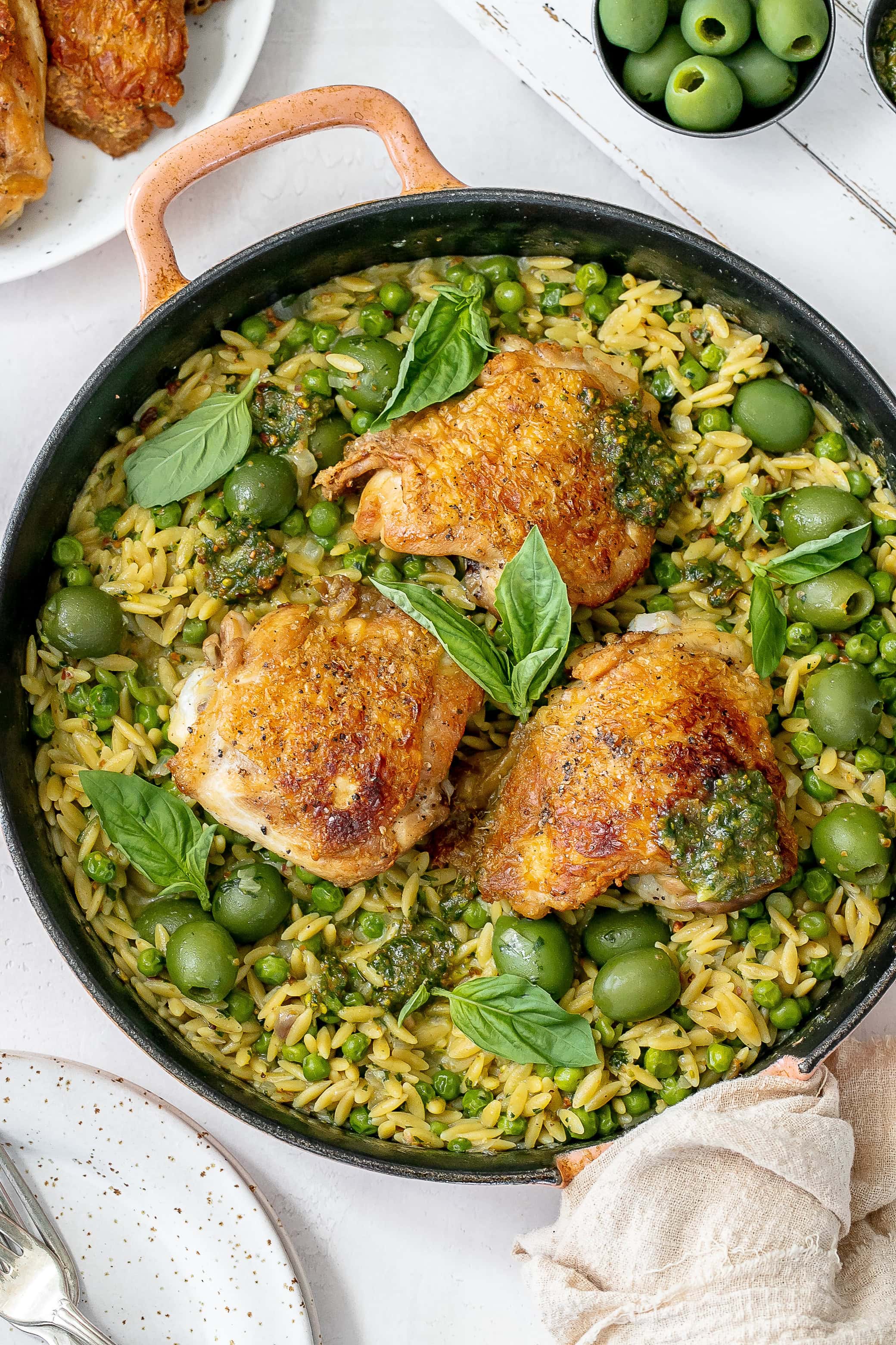 pesto chicken and orzo in cast iron skillet.