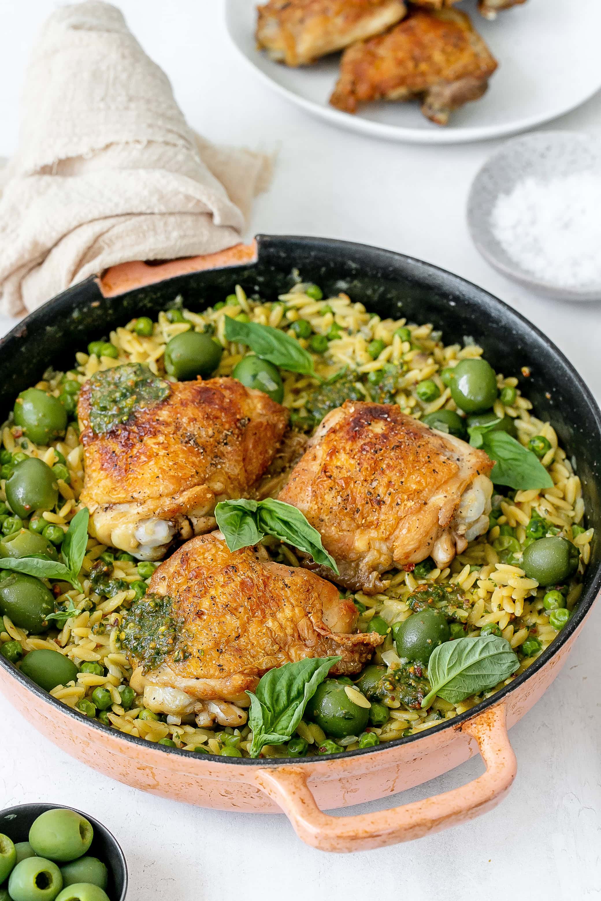 pesto chicken and orzo in cast iron skillet.