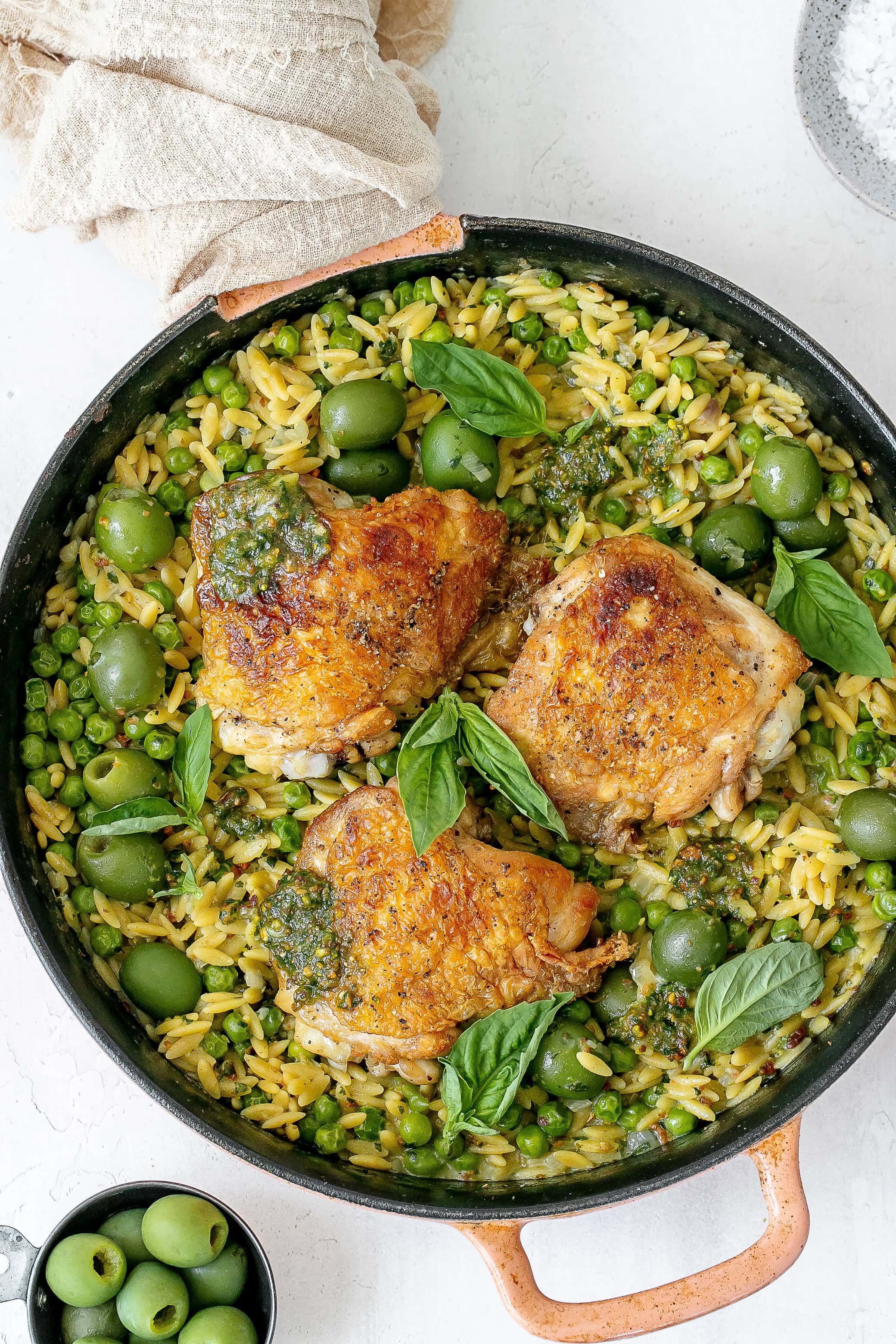 pesto chicken and orzo in cast iron skillet.