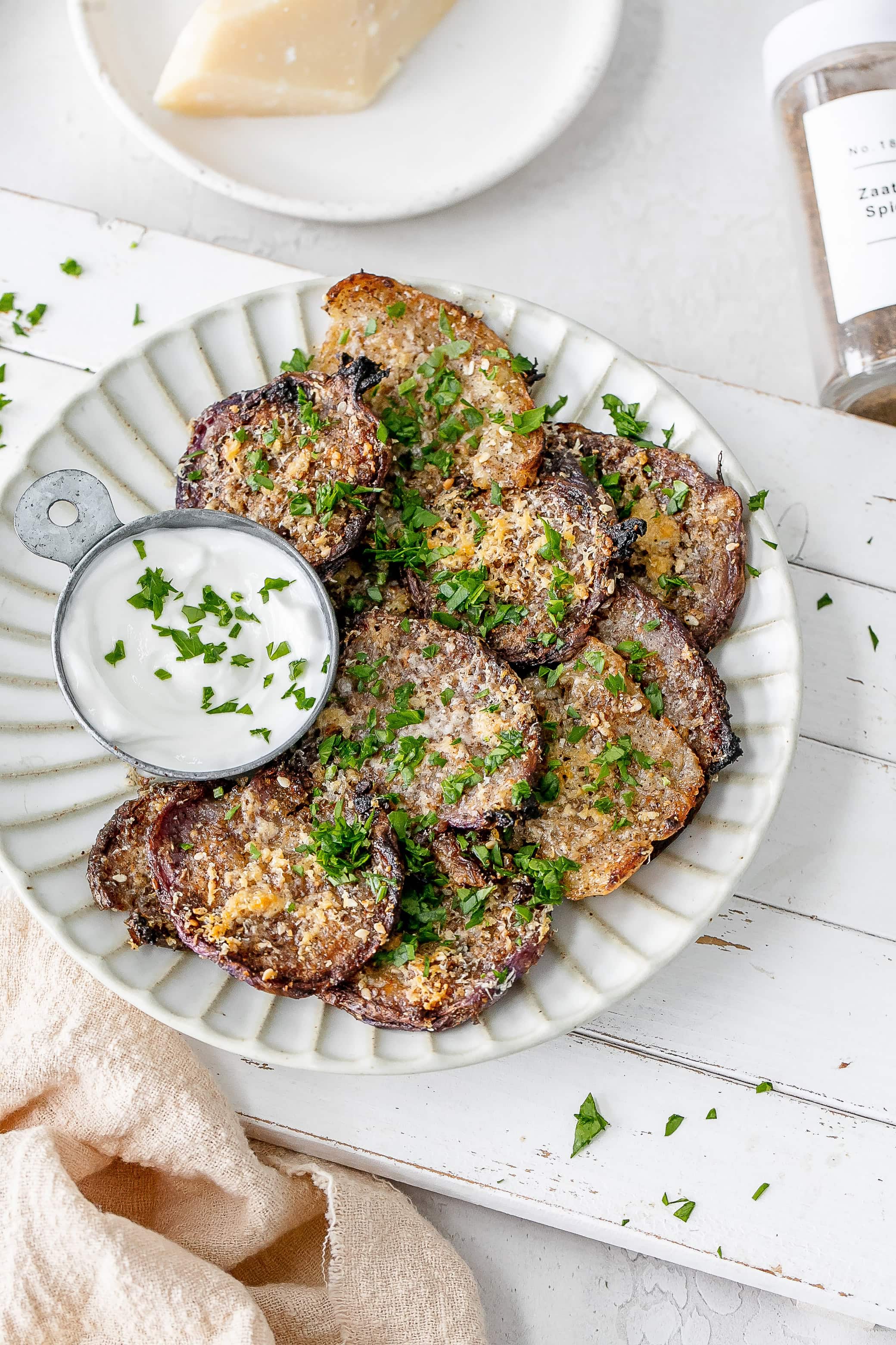 smashed radishes on a plate with dip.
