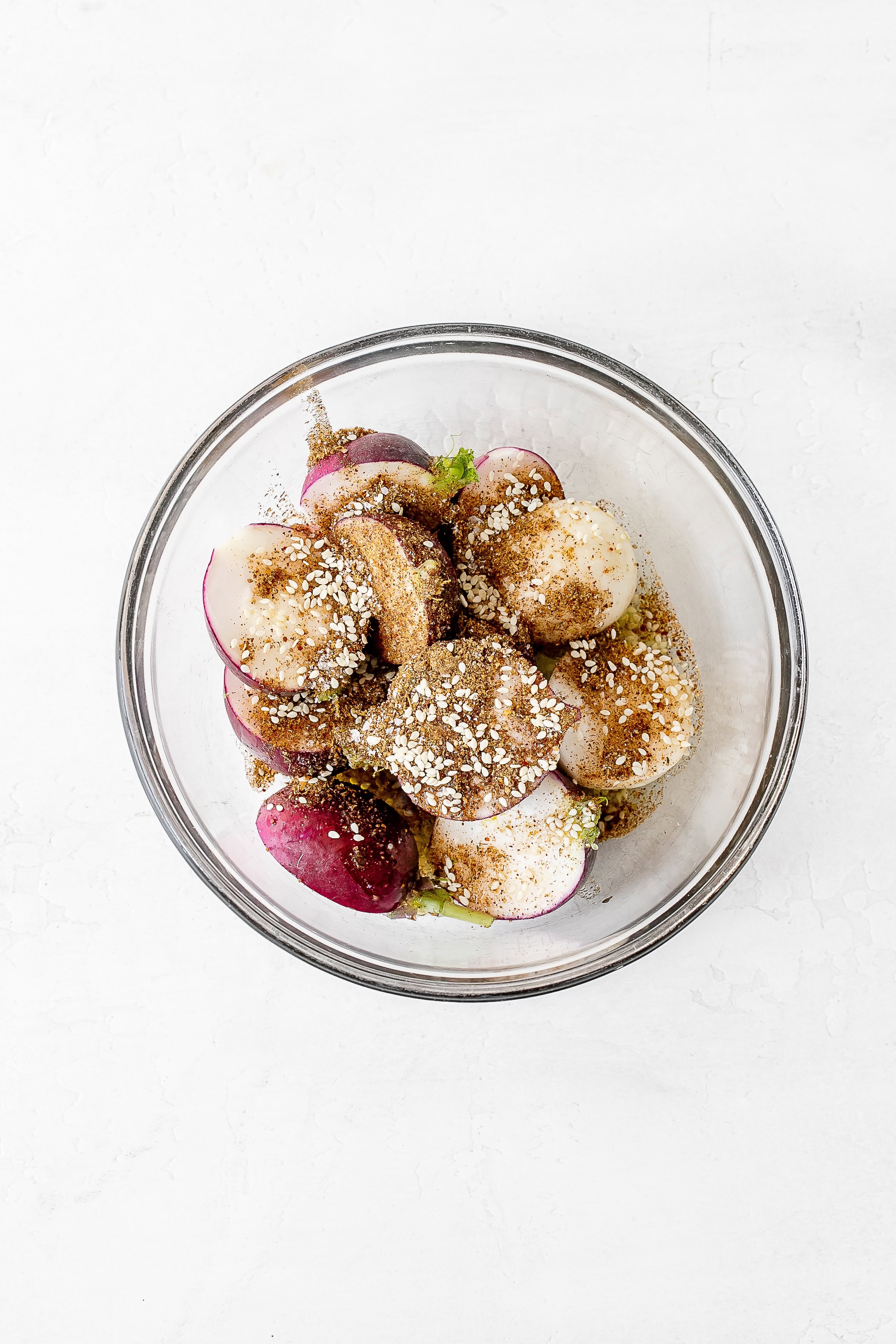 radishes in bowl with seasoning.