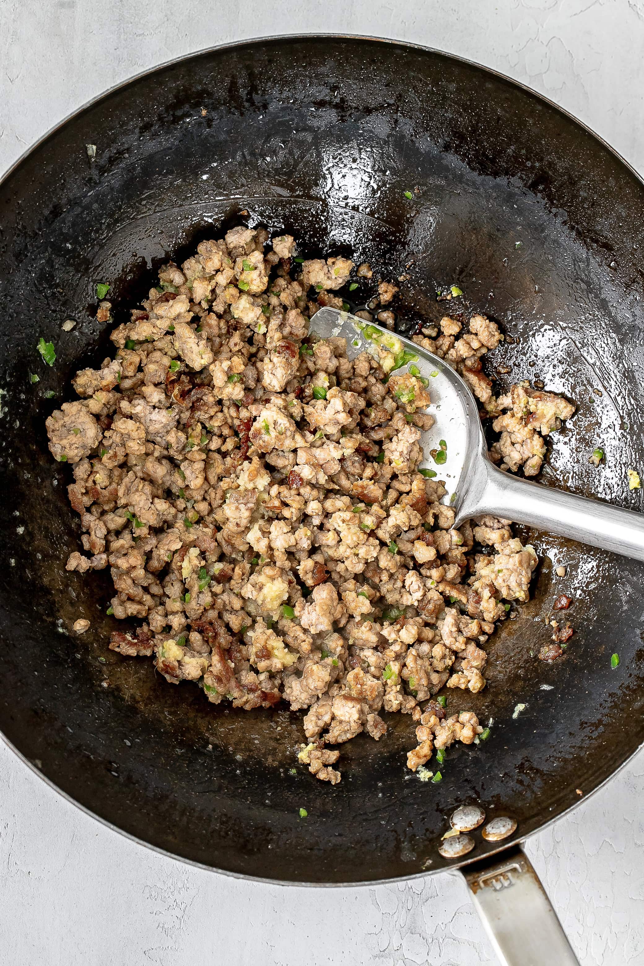 ground pork cooking in a wok.