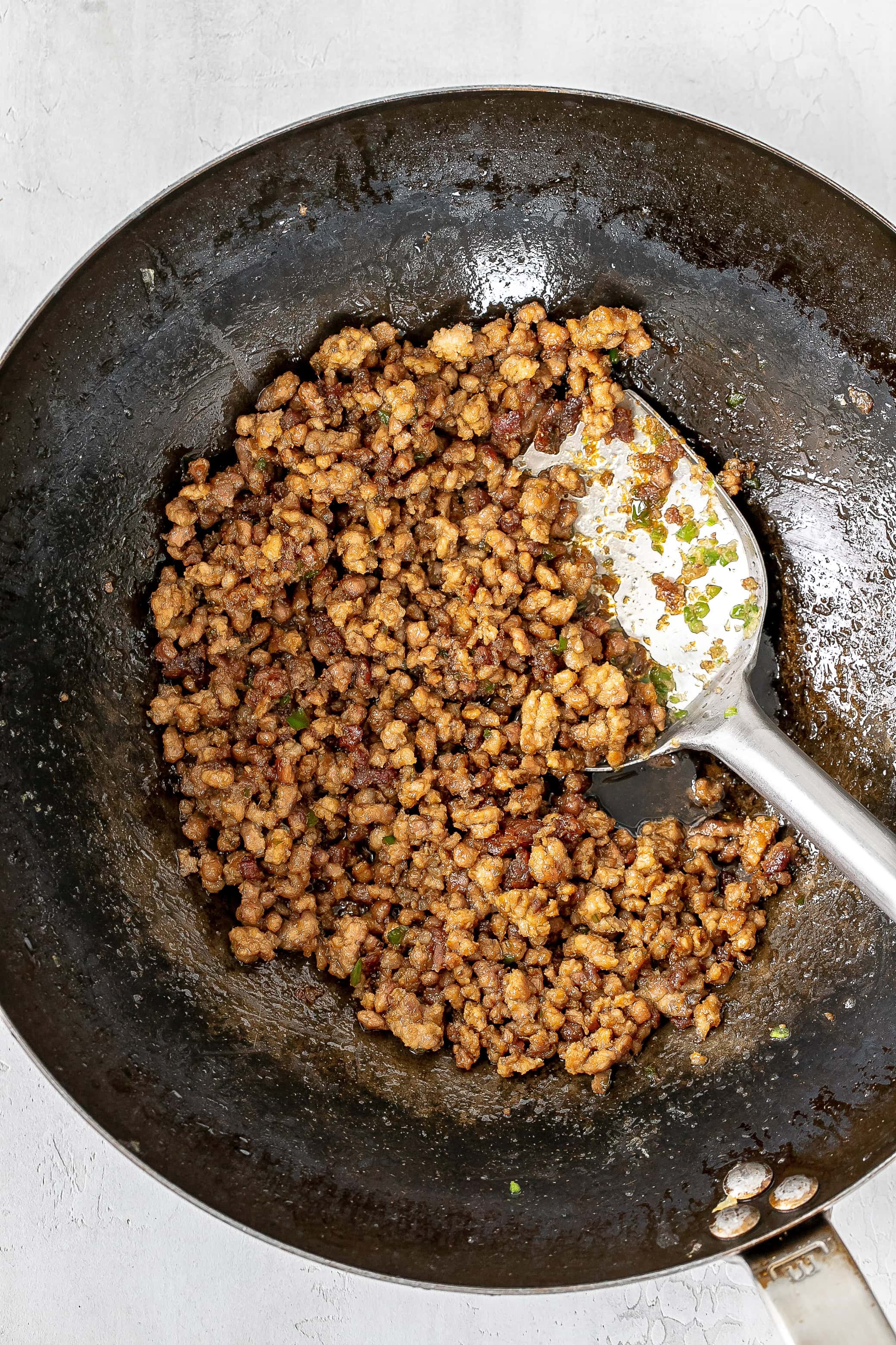 sauce added to ground pork in wok.