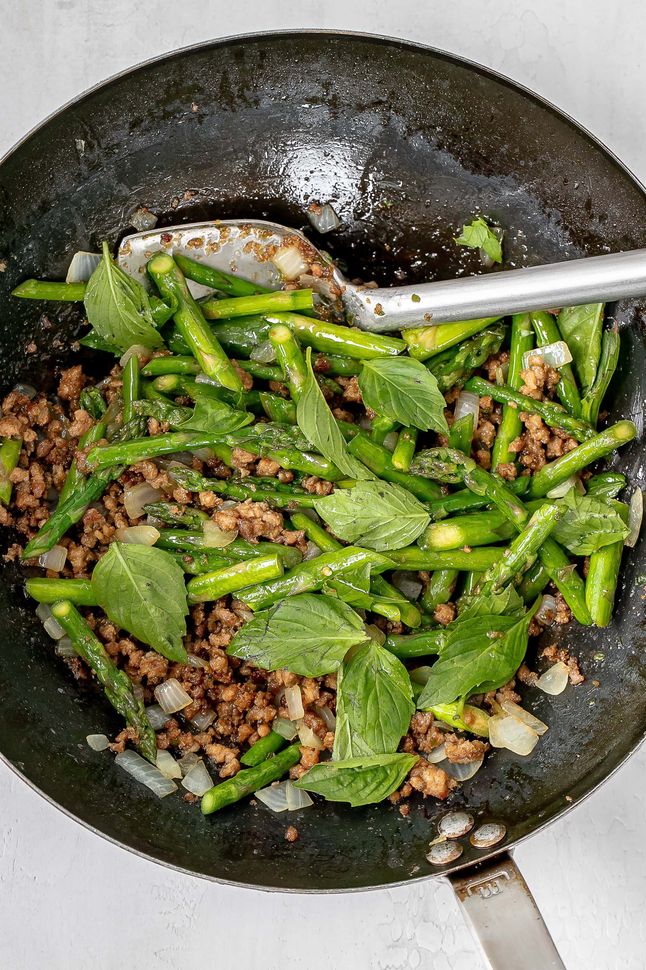 veggies and Thai basil added to wok.
