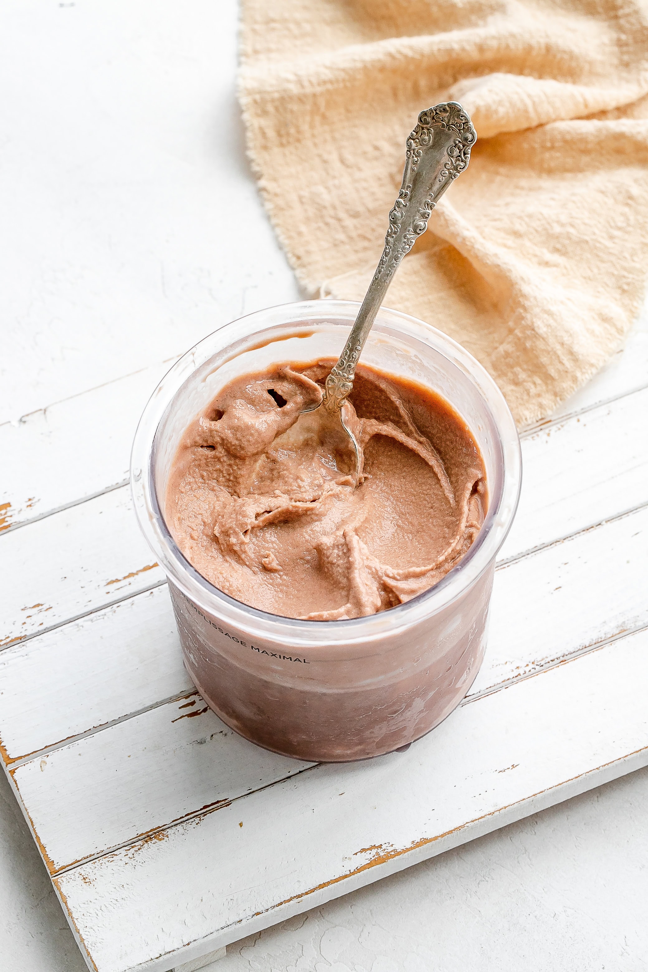 Ninja Creami frosty in a container with a spoon.