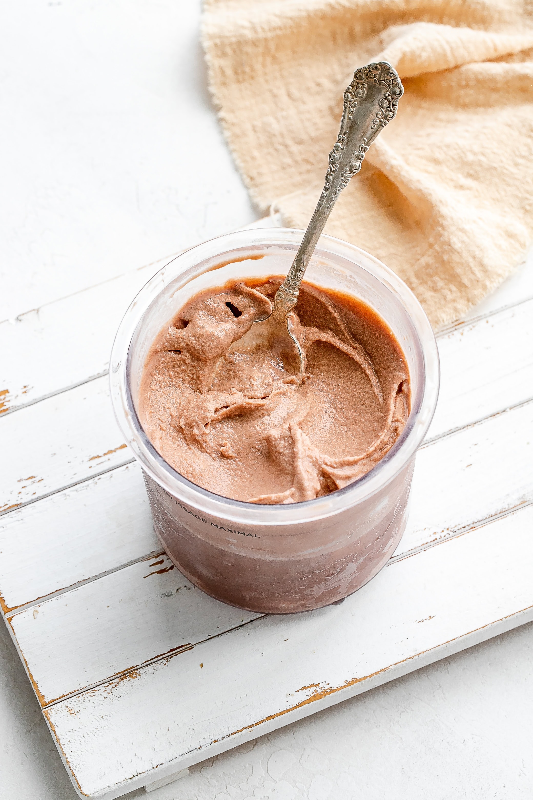 Ninja Creami frosty in a container with a spoon.