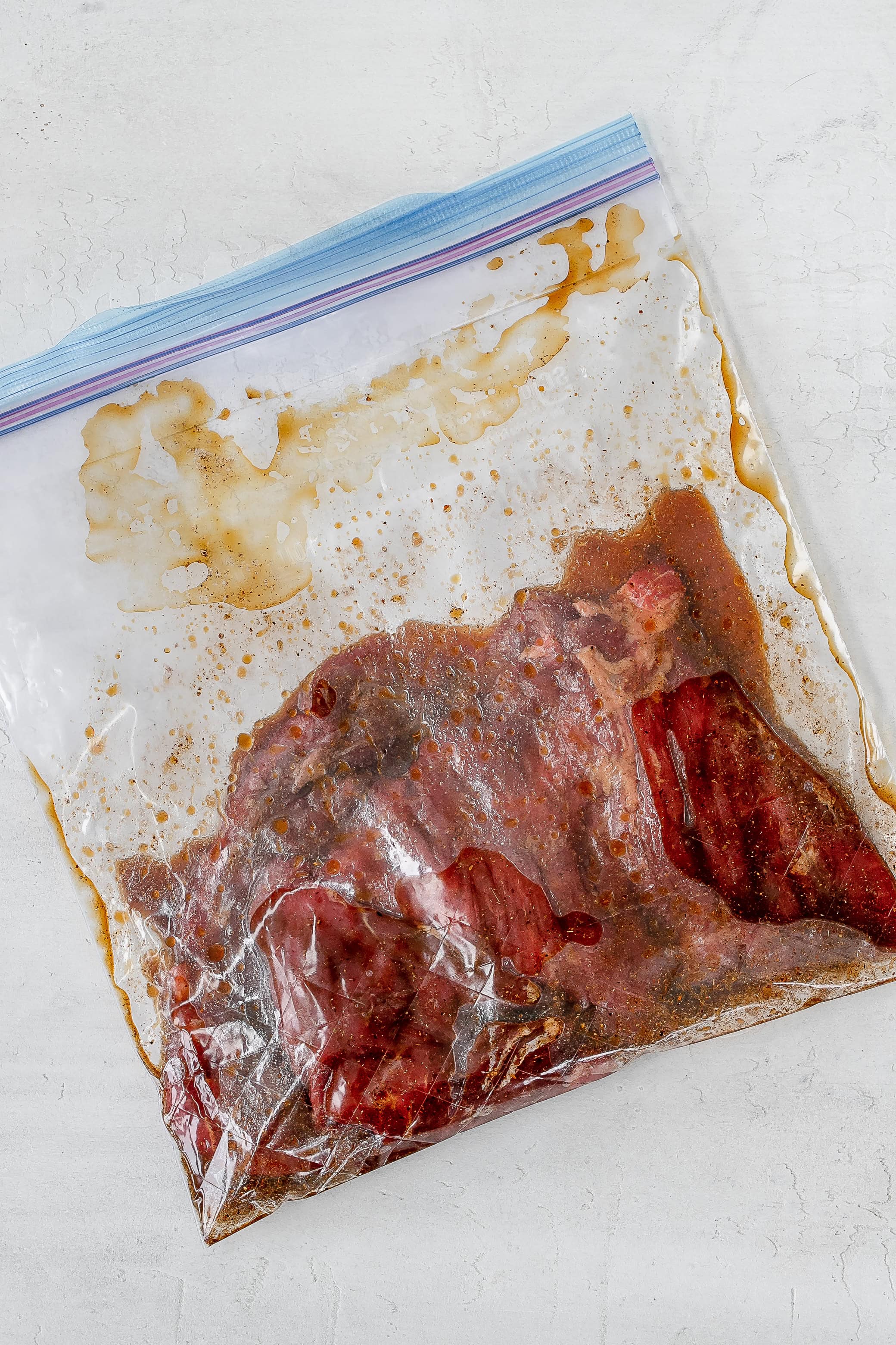 steak marinating in a ziploc bag.