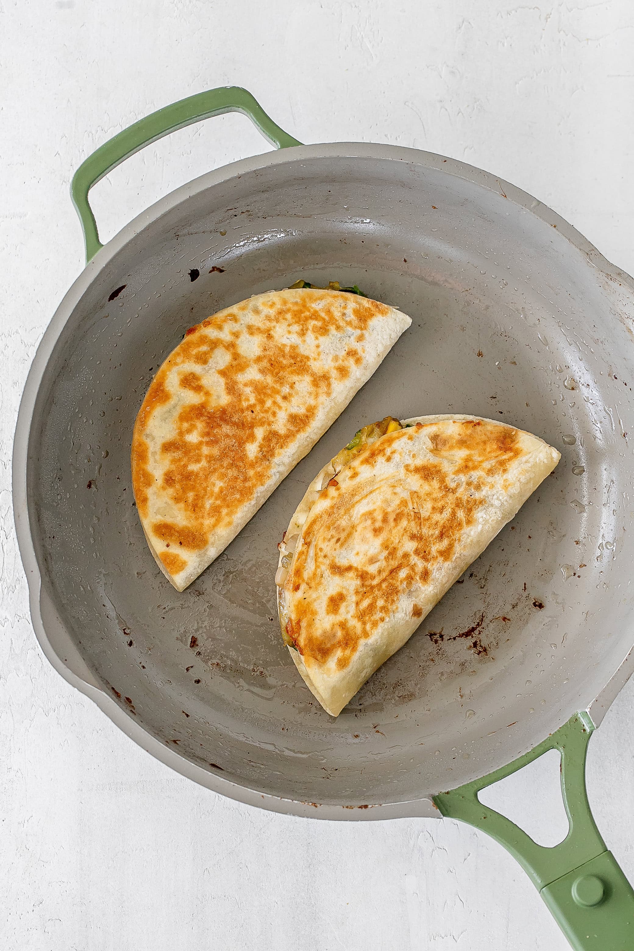 zucchini quesadillas in skillet. 