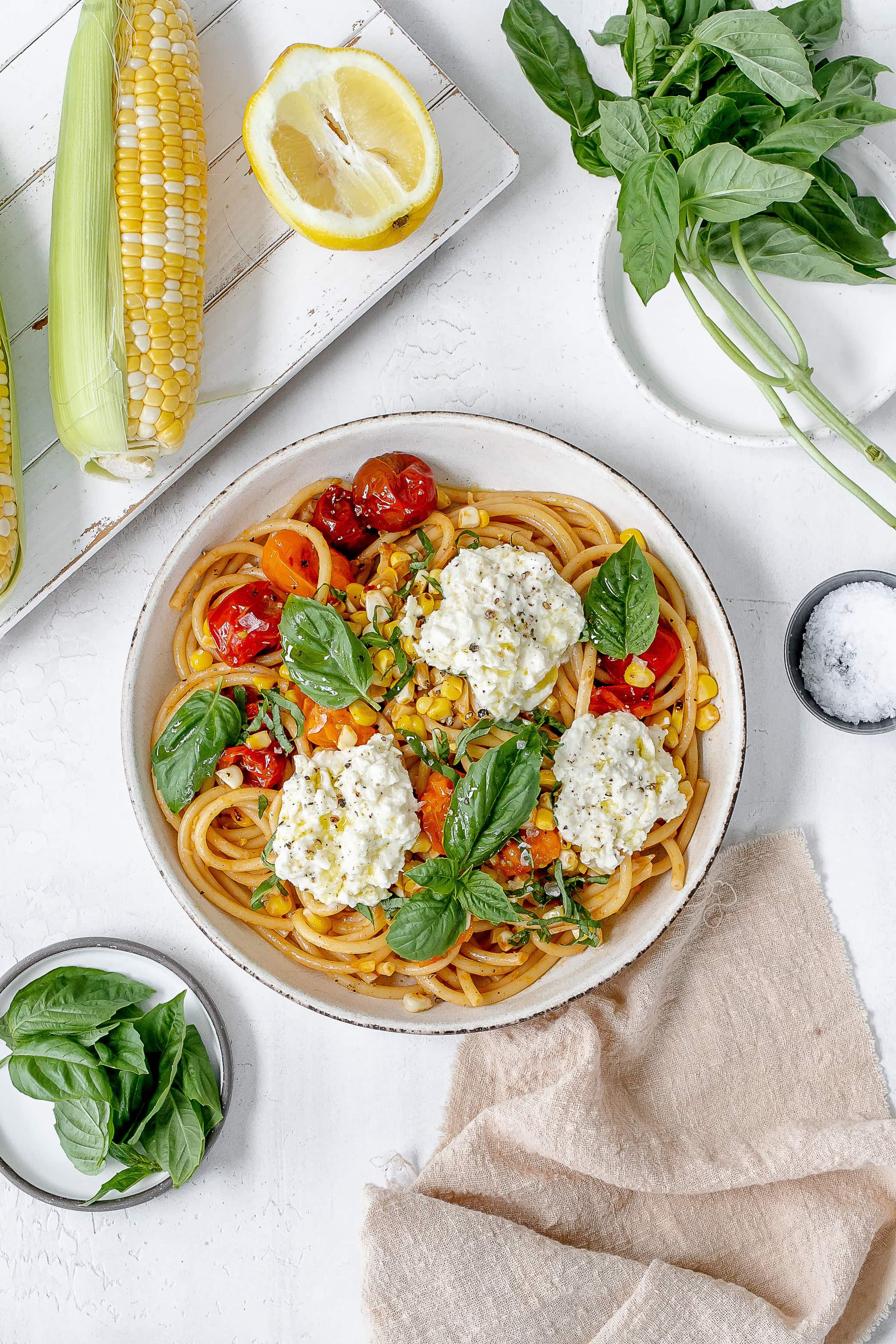 tomato and corn pasta in a pasta bowl.