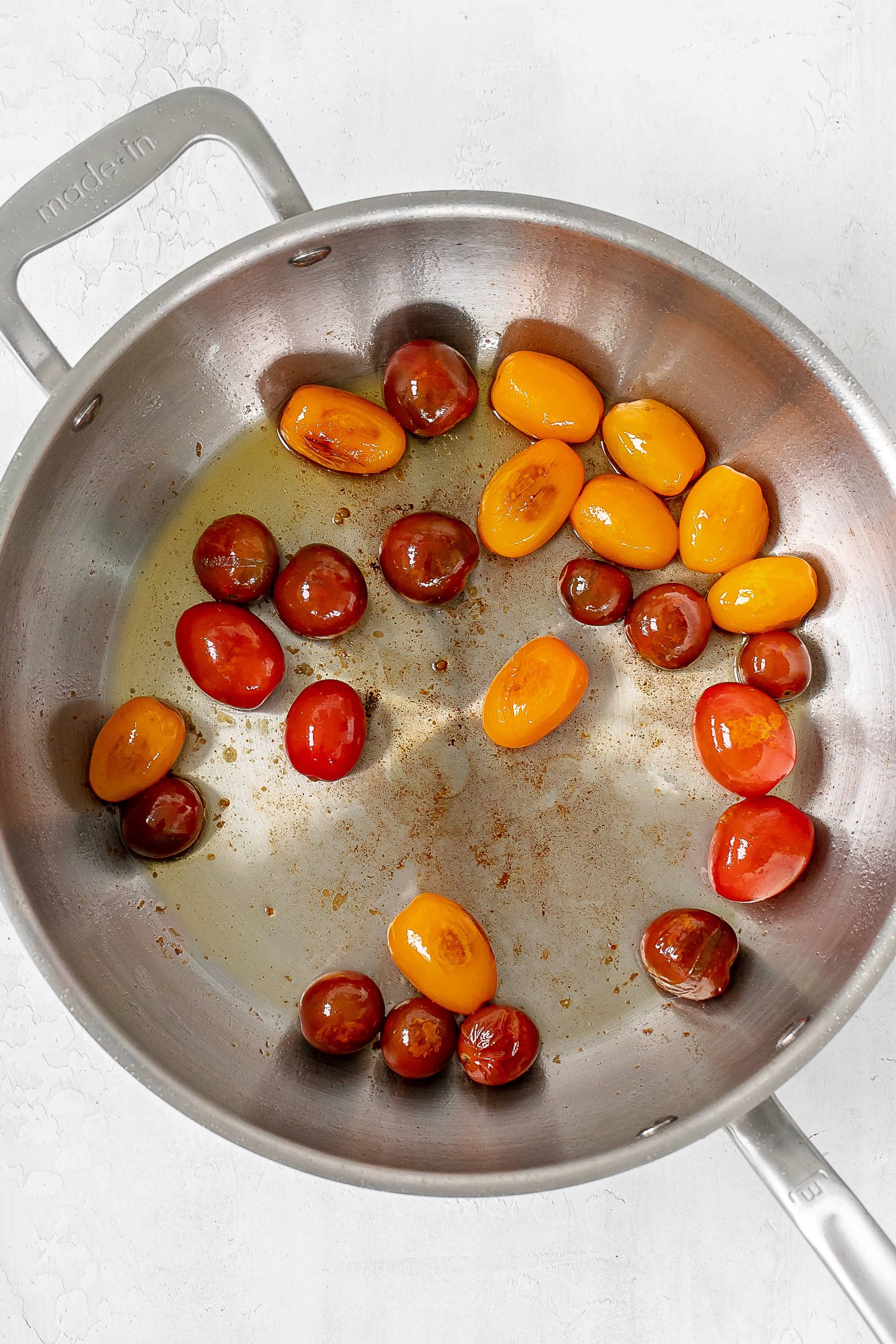 cherry tomatoes blistered in skillet.
