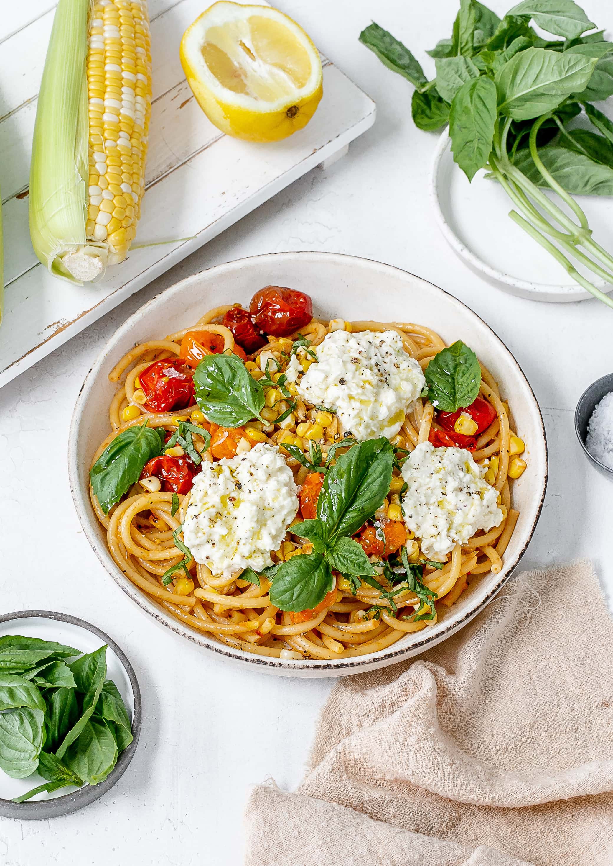 tomato and corn pasta in a pasta bowl.
