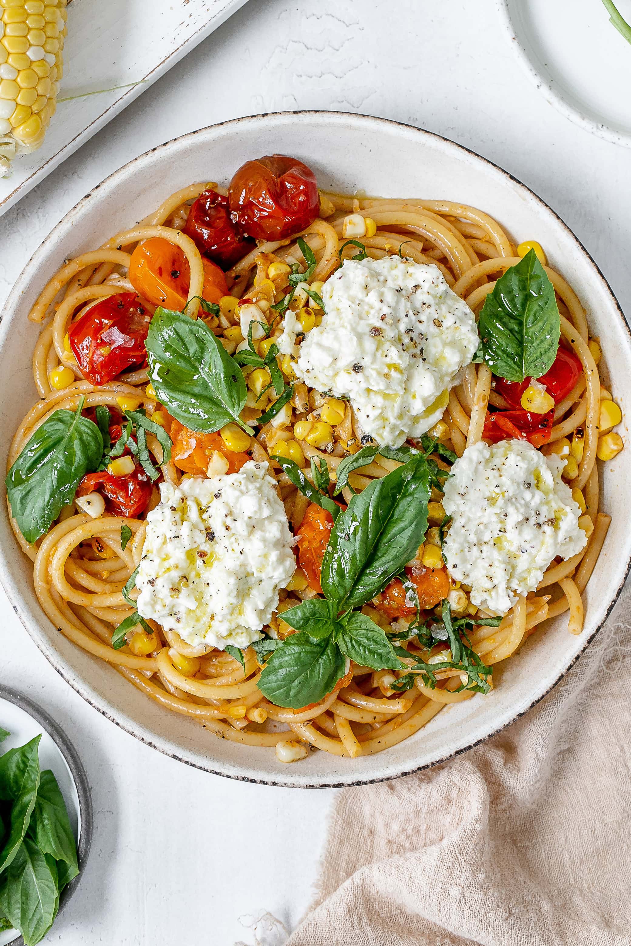 tomato and corn pasta in a pasta bowl.