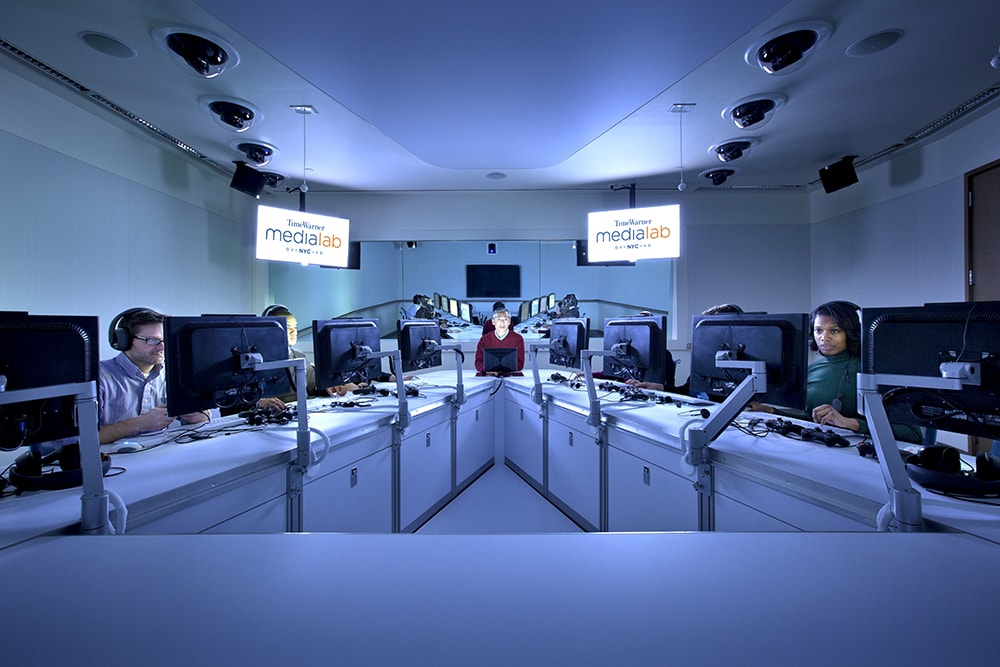 Room with many people on computers.