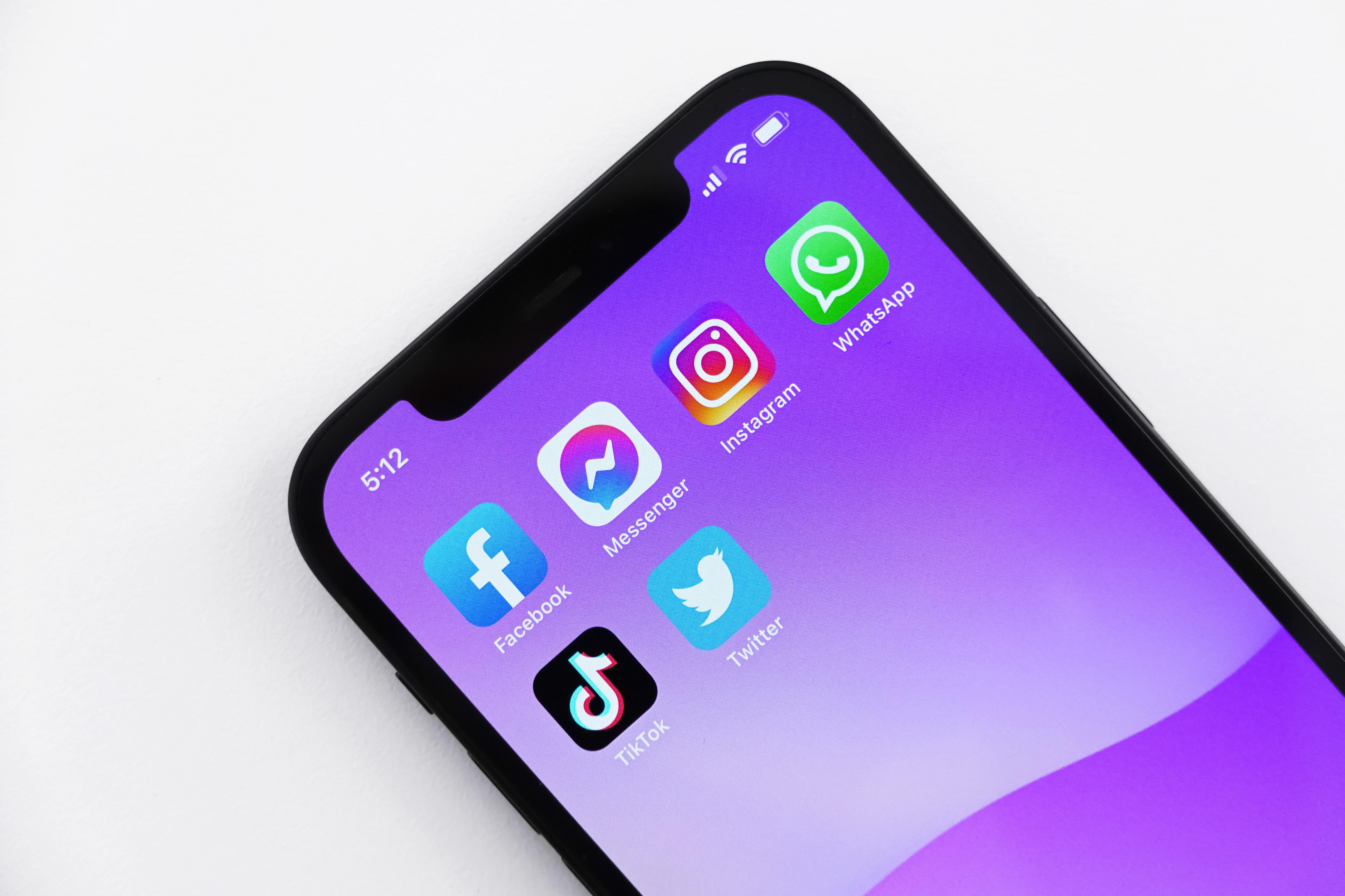 Picture of an iPhone featuring the app icons for Facebook, Messenger, Instagram, WhatsApp, TikTok, and Twitter.
