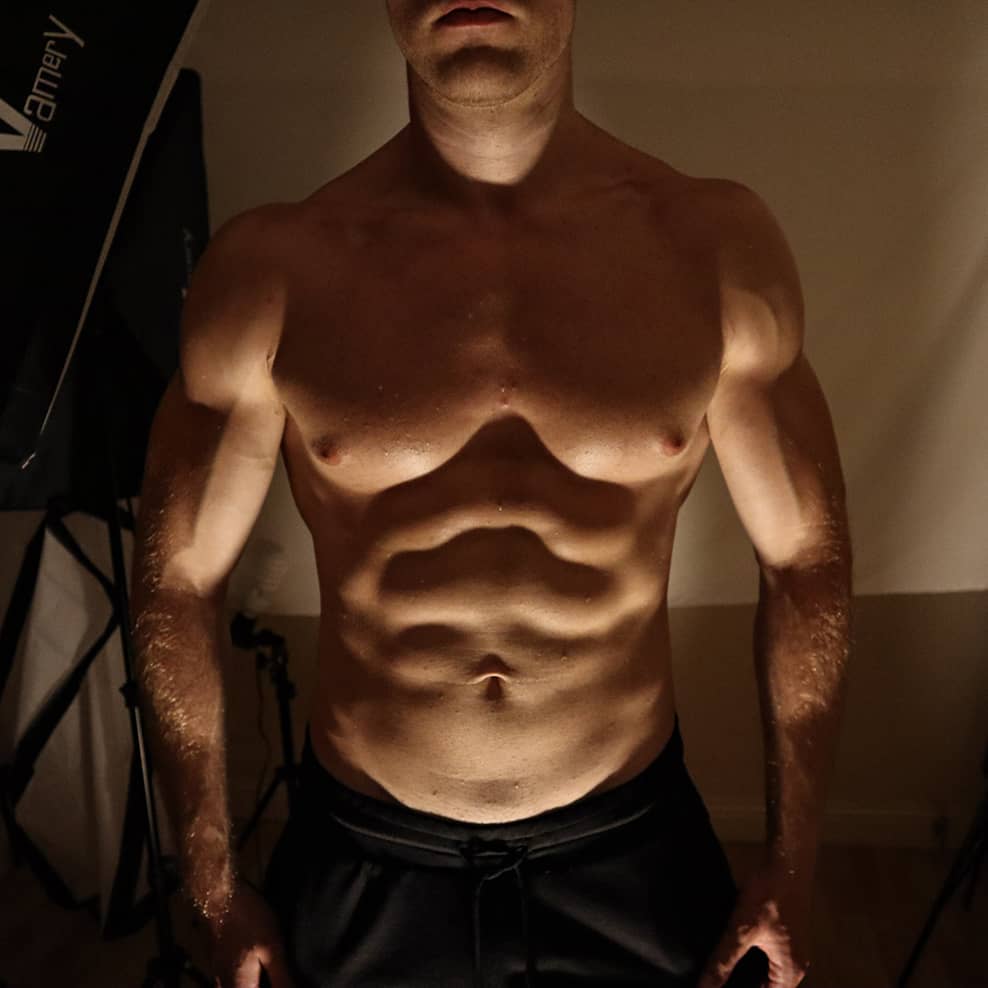 A muscular man with a six pack, big chest, arms and shoulders