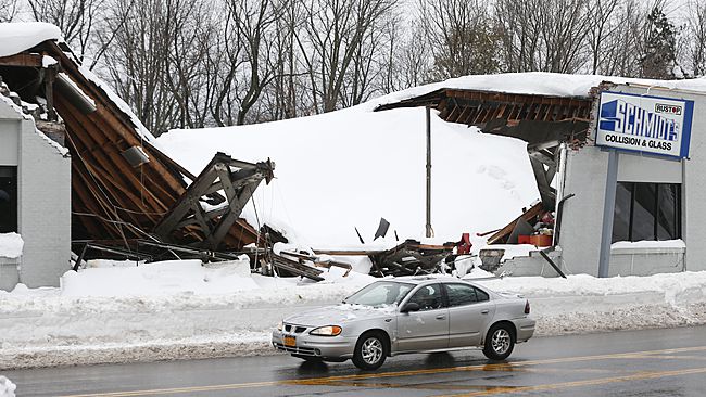 Snow build up on a business' roof causing it to collapse.