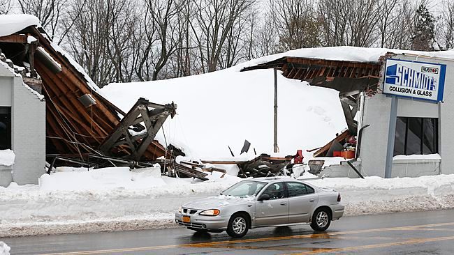 Snow build up on a business' roof causing it to collapse.
