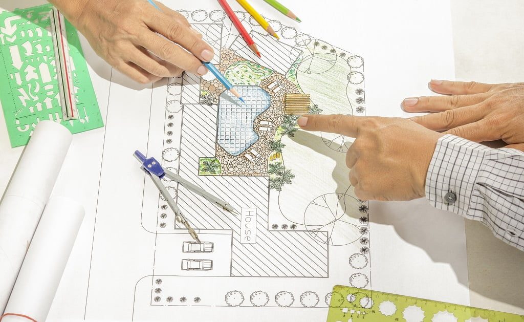 Landscape architect changing drawing at meeting with client