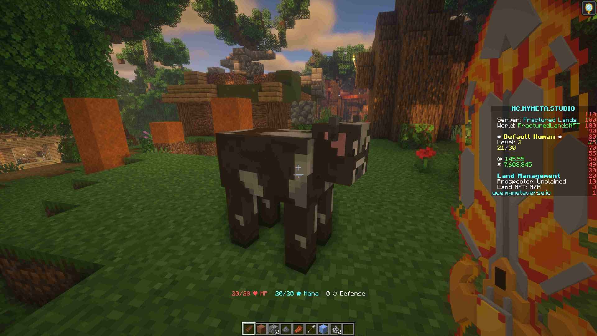 A grassy scene in Minecraft, the player is holding a large fiery sword. A brown cow stands directly in front of the player view.
