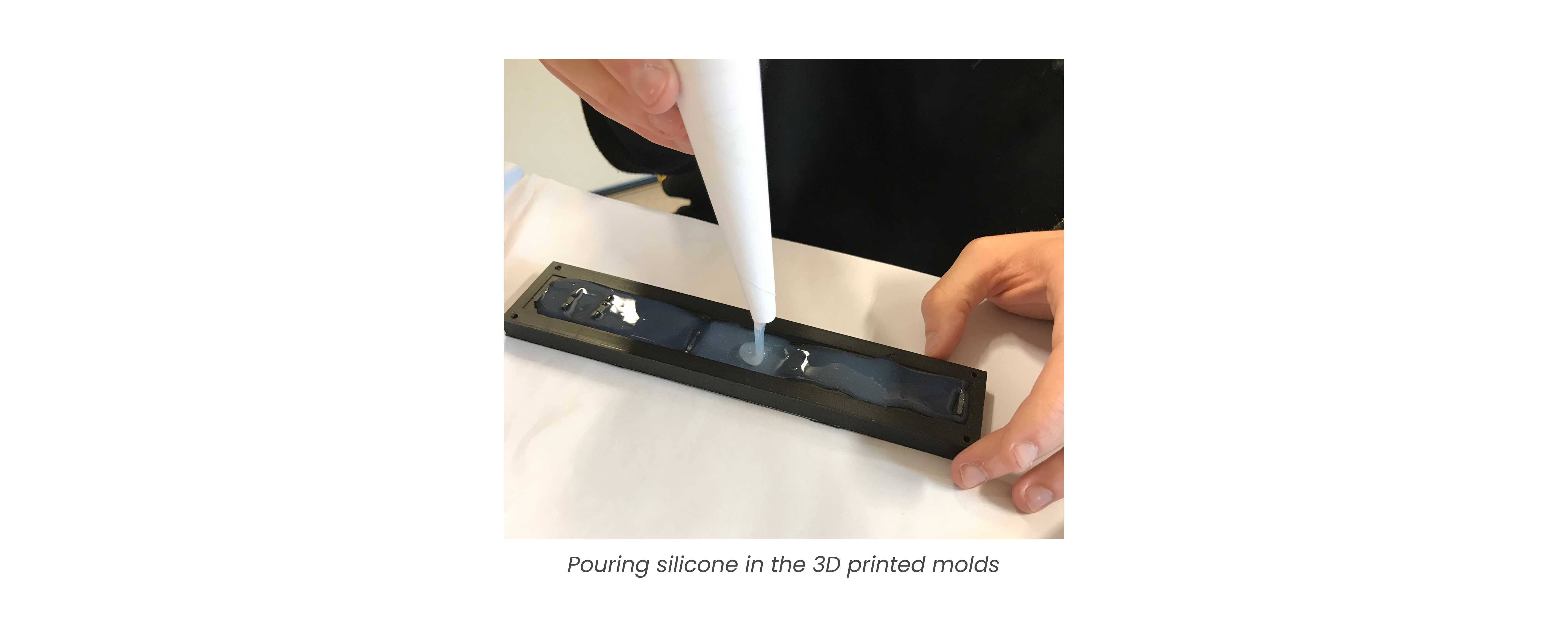 Pouring silicone into mold.