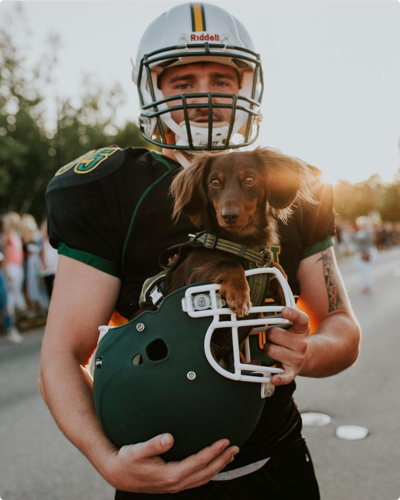 UVM Football player with dog