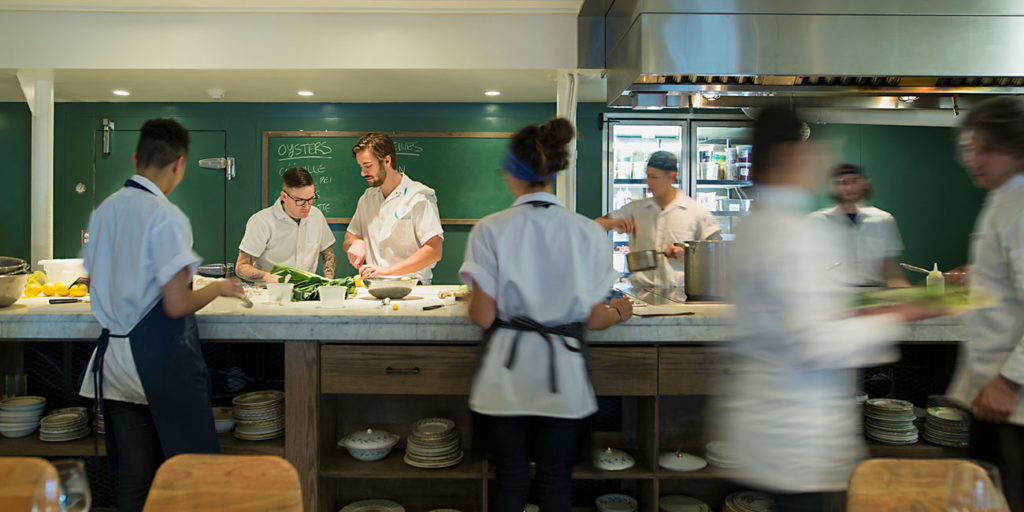 Chefs preparing food in restaurant kitchen