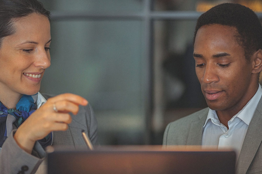young businesswoman working together with another businessman at a laptop