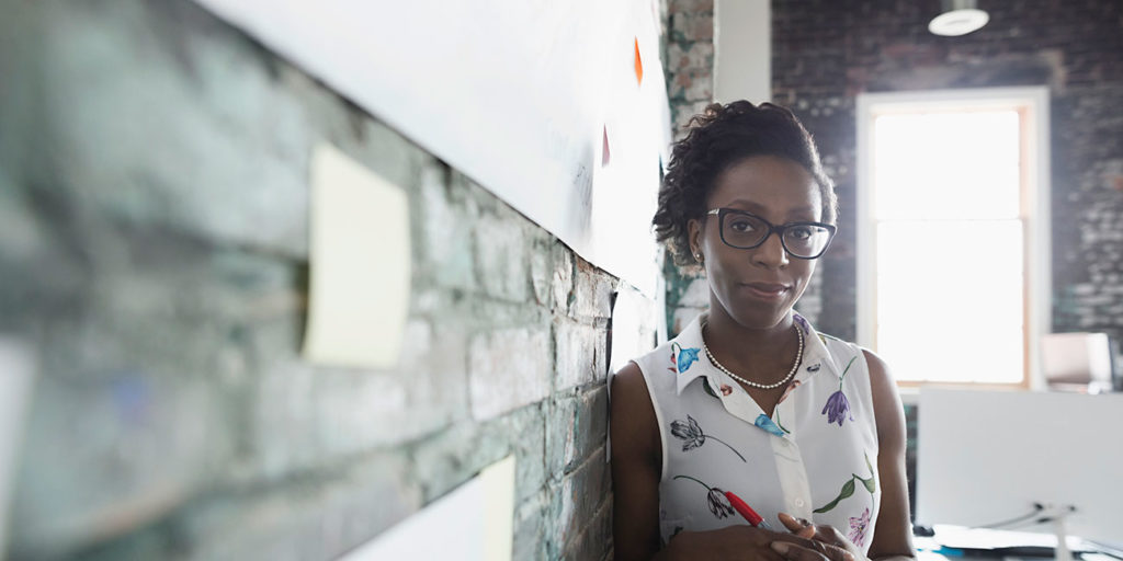 Portrait confident creative businesswoman business name brainstorming in office