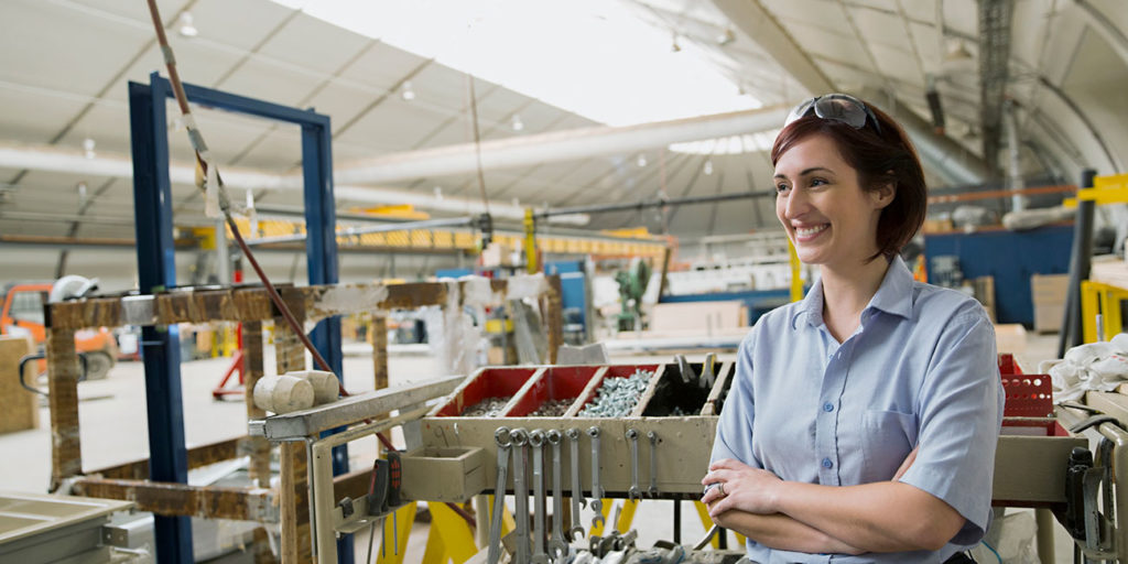 smiling female worker in manufacturing plant