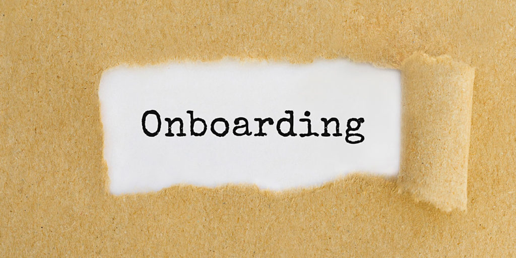 Text ONBOARDING appearing behind ripped brown paper
