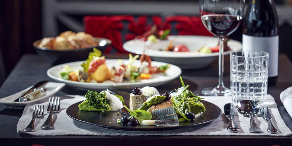 Gourmet dinner: Delicate fish carefully arranged with green vegetables