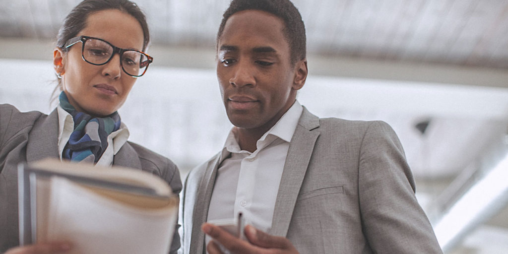 Young businesswoman and man having a conversation in modern office
