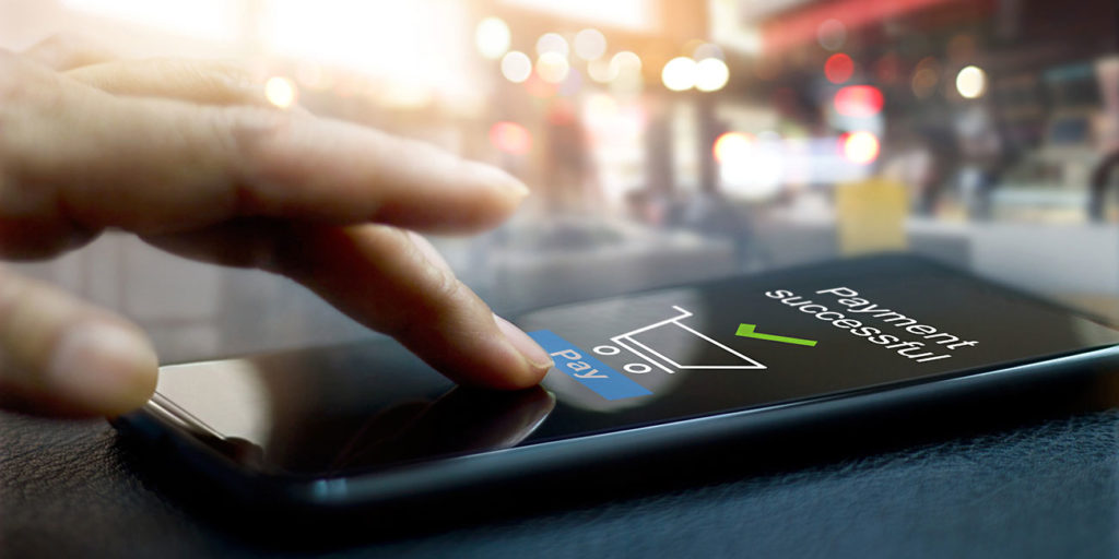 Hand on smartphone using shopping cart software app