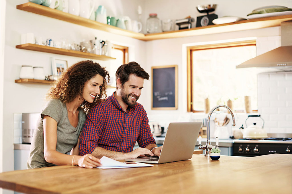 Cropped shot of a young couple working on a laptop together at home