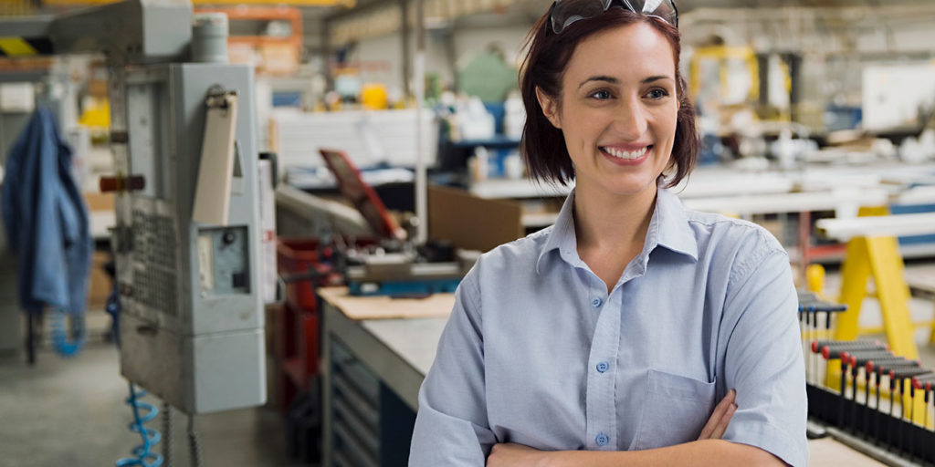smiling female worker in manufacturing plant