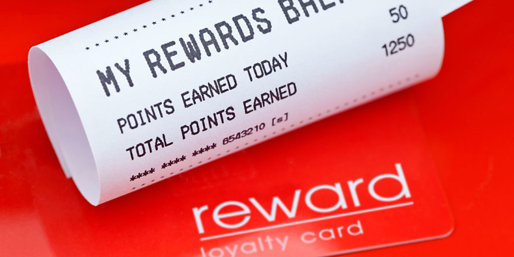 red customer loyalty program rewards card and receipt showing balance