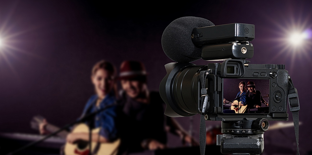 Camera for photographer or Video and Live Streaming concept, Professional digital Mirrorless camera with microphone recording video blog of Musician duo band singing a song and playing music instrument