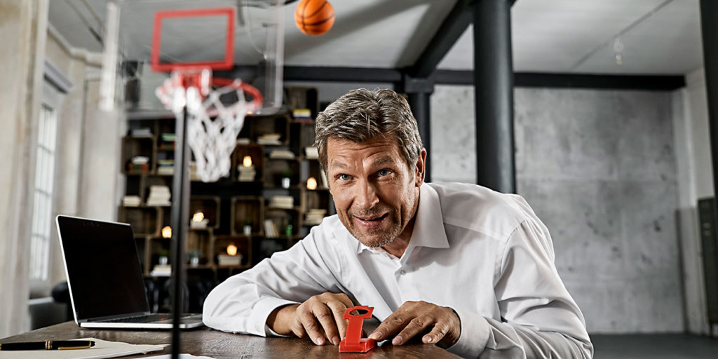 Portrait of mature businessman playing office games in loft