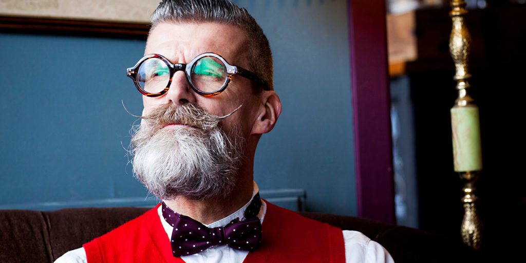 Portrait of stylish quirky senior man vintage cafe