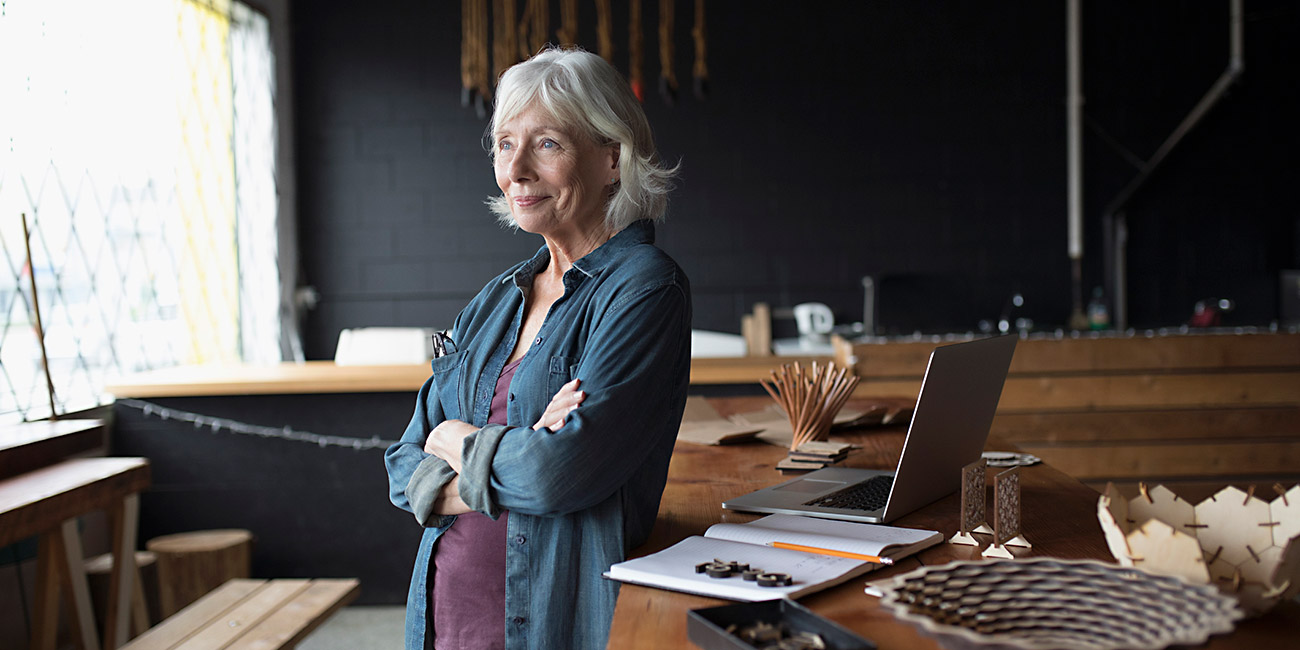 senior female entrepreneur looking away at window