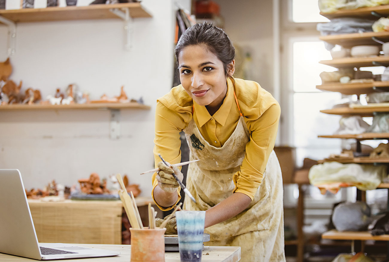 Portrait of a Young Woman Creating Pottery, Using Laptop|Tips for Self Employed Success