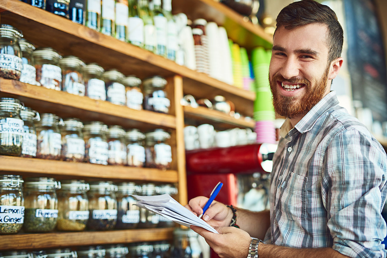 Cropped shot of a male shop owner doing some paperwork|Word 