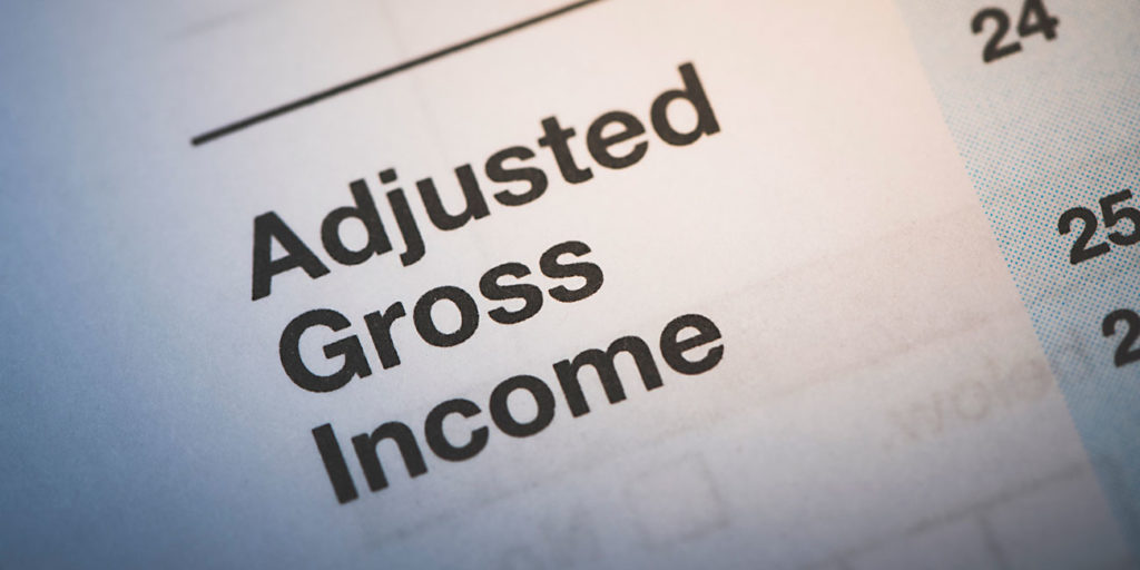 a 1040 IRS Tax form. Focused not he words adjusted gross income - AGI