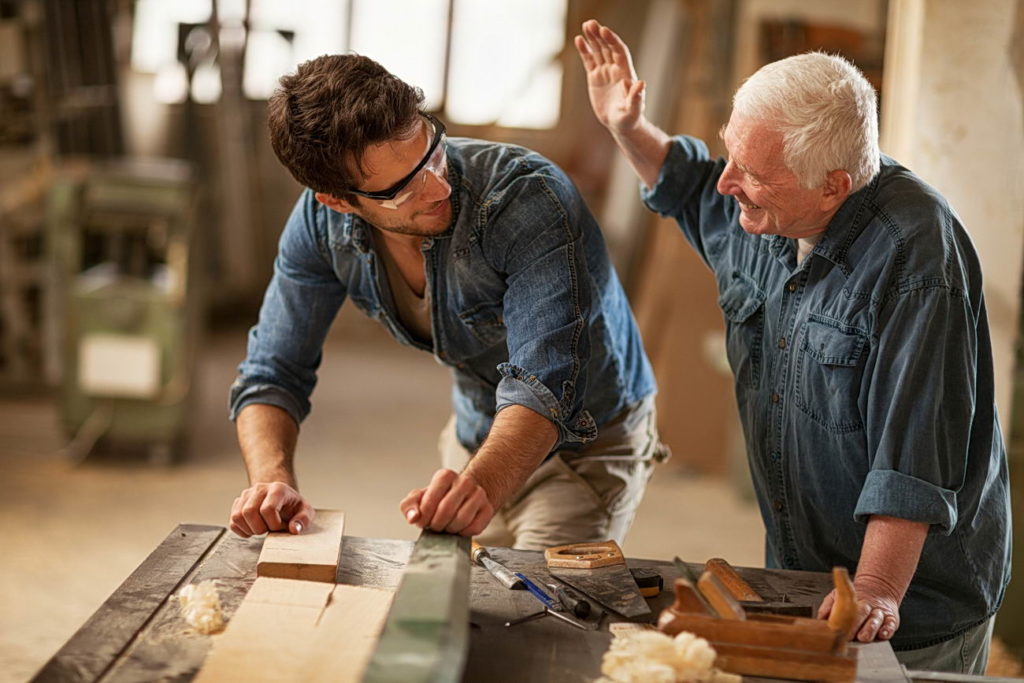 Father and son carpenters working togethe