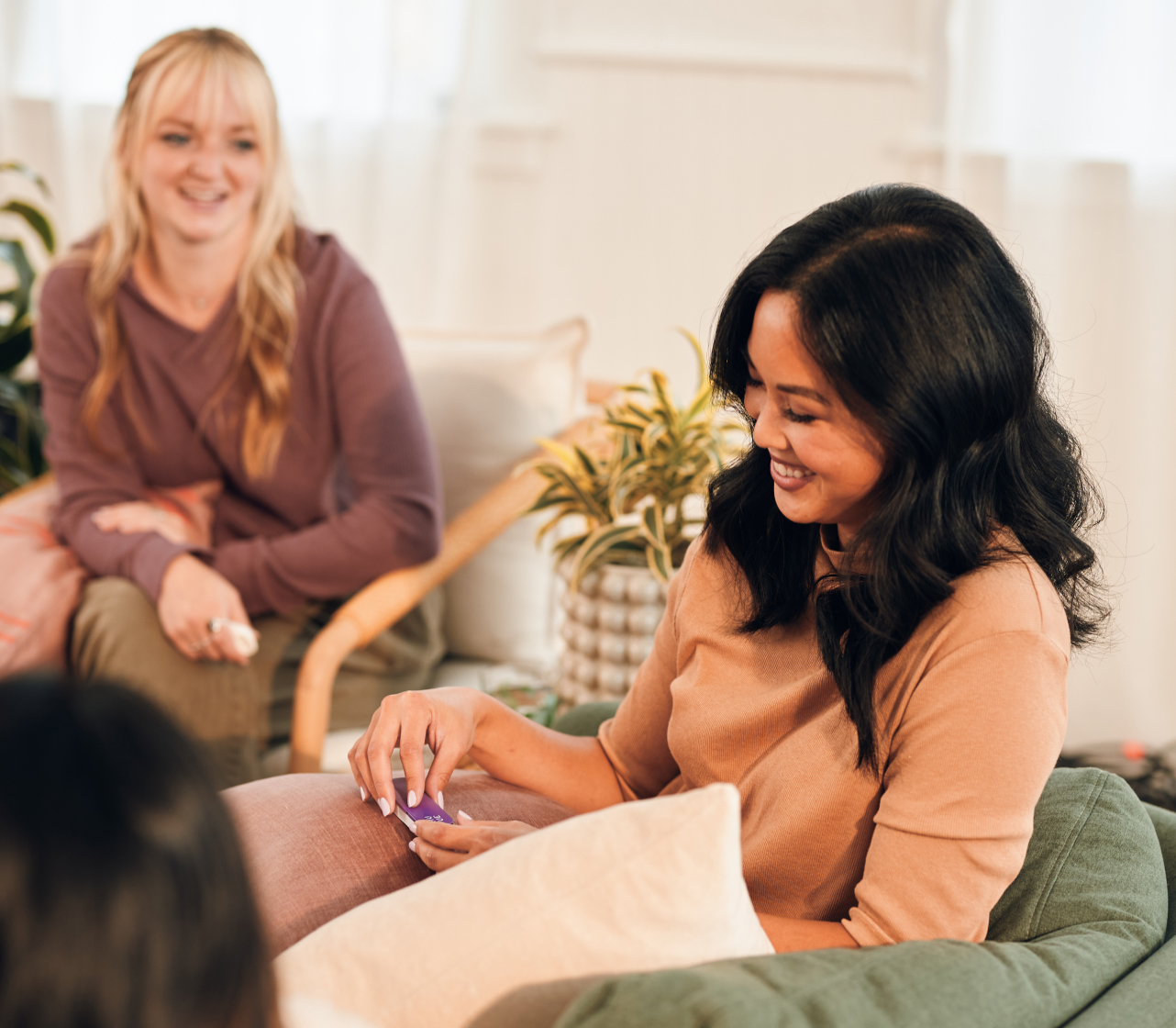 Three women relaxing in the living room with Unwine