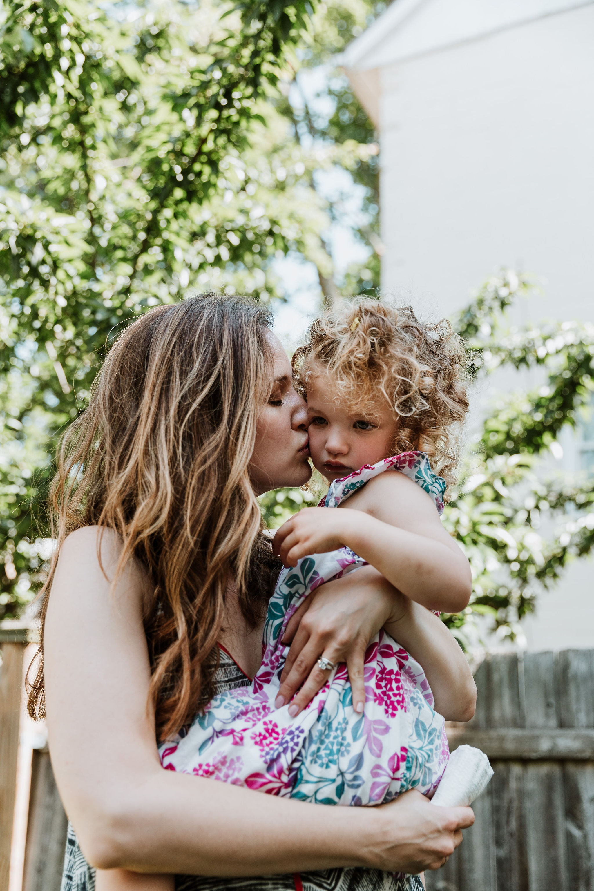 Dr Ariana postpartum mom pediatrician, kissing daughter outside