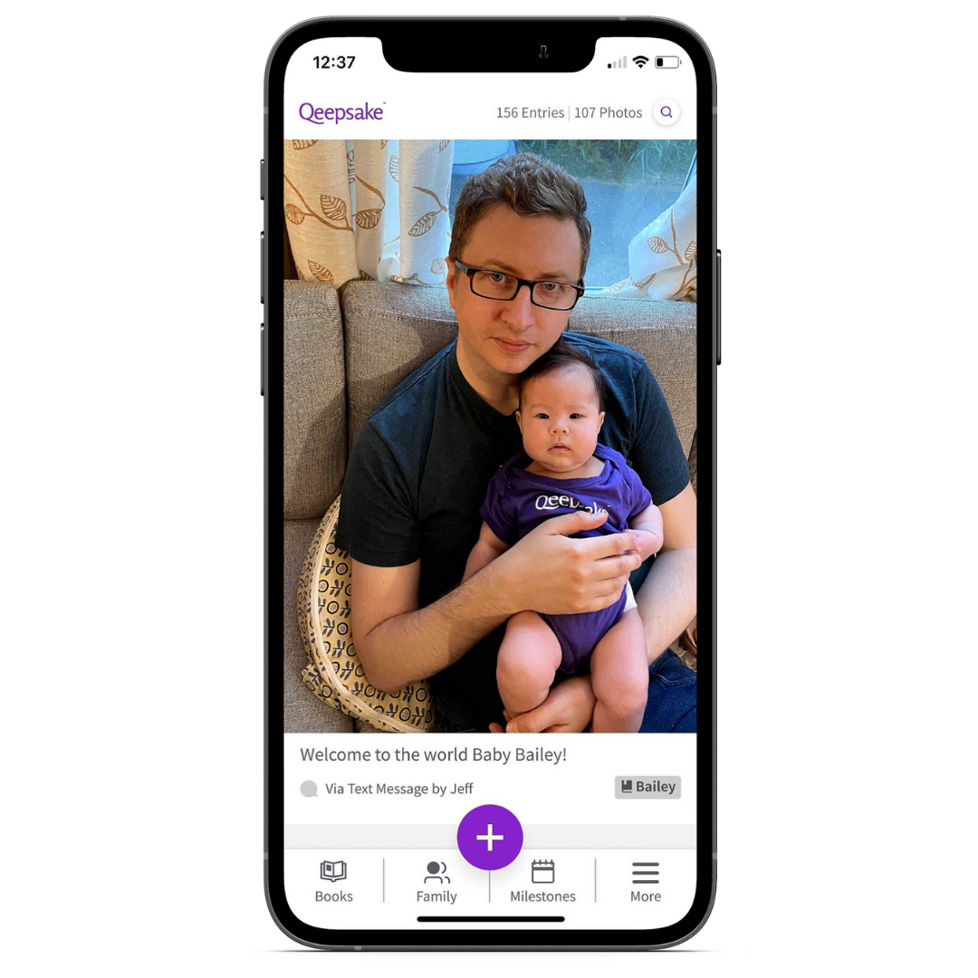 An iphone showcasing the Qeepsake App. It is an entry of Qeepsake's CEO & Co-Founder, Jeff McNeil CEO's founder family with his sixth daughter Bailey. The picture is of Jeff and Bailey and the entry says Welcome to the world Baby Bailey! It is a text send in from Jeff to Bailey's journal which has 156 entries and 107 photos.